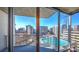 Balcony view of a cityscape with a pool below; bright sky and high-rise buildings are visible at 860 Peachtree Ne St # 917, Atlanta, GA 30308