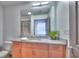 Bathroom featuring a vanity, a granite countertop, a framed mirror, and a glass shower at 860 Peachtree Ne St # 917, Atlanta, GA 30308