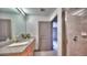 Well-lit bathroom featuring a granite-topped vanity, and a tiled walk-in shower at 860 Peachtree Ne St # 917, Atlanta, GA 30308