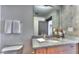 Modern bathroom vanity with granite countertop, decorative fixtures, and stylish mirror at 860 Peachtree Ne St # 917, Atlanta, GA 30308