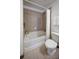 Clean bathroom featuring a standard bathtub and a white toilet. A shower curtain is also featured at 860 Peachtree Ne St # 917, Atlanta, GA 30308