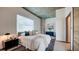 Cozy bedroom showcasing a comfy bed, concrete ceiling, and bright window lighting the space at 860 Peachtree Ne St # 917, Atlanta, GA 30308