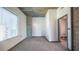 Bedroom features neutral walls, gray carpet, and a view into the bathroom with a toilet and vanity at 860 Peachtree Ne St # 917, Atlanta, GA 30308
