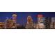 The city skyline is aglow with lights at night and the view captures several skyscrapers at 860 Peachtree Ne St # 917, Atlanta, GA 30308