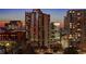 Picturesque city view with modern high-rise apartments featuring abundant windows during twilight hours at 860 Peachtree Ne St # 917, Atlanta, GA 30308