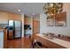 Open-concept dining area featuring wood floors, modern lighting, and stainless steel appliances at 860 Peachtree Ne St # 917, Atlanta, GA 30308