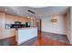 Open kitchen featuring stainless appliances, wood cabinets, island bar, and hardwood flooring at 860 Peachtree Ne St # 917, Atlanta, GA 30308