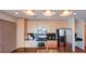 Bright kitchen with wood cabinets, stainless steel appliances, black tile backsplash, and granite countertops at 860 Peachtree Ne St # 917, Atlanta, GA 30308