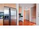 Modern kitchen featuring stainless steel appliances, black tile backsplash, and wood floors at 860 Peachtree Ne St # 917, Atlanta, GA 30308