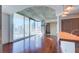 Open-concept living space with concrete ceiling, wood floors, and expansive windows showcasing city views at 860 Peachtree Ne St # 917, Atlanta, GA 30308