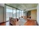 Cozy living room featuring large windows with city views, modern furnishings, and hardwood floors at 860 Peachtree Ne St # 917, Atlanta, GA 30308