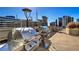 Outdoor kitchen on a rooftop terrace featuring stainless steel gas grills, plus lounge seating, and city views at 860 Peachtree Ne St # 917, Atlanta, GA 30308