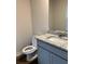 Modern half-bath with granite counters and sleek gray vanity at 903 Jackson Oak Place, Villa Rica, GA 30180