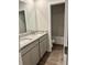 Bathroom with a double sink vanity, granite counters, and views into the shower and tub area at 903 Jackson Oak Place, Villa Rica, GA 30180