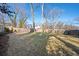 Spacious backyard featuring a well-maintained lawn, mature trees, and a sturdy wooden fence for privacy at 1589 Mims Sw St, Atlanta, GA 30314