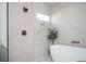 Bright bathroom featuring bronze shower fixtures, a freestanding tub, and glass shower at 1589 Mims Sw St, Atlanta, GA 30314