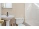 Bathroom with a pedestal sink, toilet, and bathtub at 1589 Mims Sw St, Atlanta, GA 30314