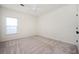 Neutral bedroom with a ceiling fan, window, and carpeted floors at 1589 Mims Sw St, Atlanta, GA 30314