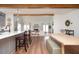 Kitchen island with a white countertop and seating area, flowing into a living area with a fireplace at 1589 Mims Sw St, Atlanta, GA 30314