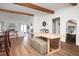 Open-concept living room with wood beams, wood floors, fireplace, and a smooth transition to the dining area at 1589 Mims Sw St, Atlanta, GA 30314