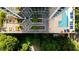 Aerial view of building with a pool and outdoor lounge area surrounded by landscaping at 2828 Peachtree Nw Rd # 701, Atlanta, GA 30305