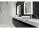 Modern bathroom features double sinks, backlit mirrors, black marble accent wall, and marble flooring at 2828 Peachtree Nw Rd # 701, Atlanta, GA 30305