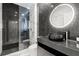 Modern bathroom features glass-enclosed shower, sleek vanity, black marble and a vessel sink at 2828 Peachtree Nw Rd # 701, Atlanta, GA 30305