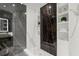 Contemporary bathroom with walk-in shower, marble and black marble accent, and built-in shelving at 2828 Peachtree Nw Rd # 701, Atlanta, GA 30305
