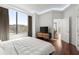 Bright bedroom with hardwood floors, large windows, and a view of the city at 2828 Peachtree Nw Rd # 701, Atlanta, GA 30305