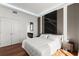 Bedroom with hardwood floors, king bed, closet doors and ensuite bathroom access at 2828 Peachtree Nw Rd # 701, Atlanta, GA 30305