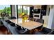 Bright dining room with marble table, seating for eight, and view of lush greenery at 2828 Peachtree Nw Rd # 701, Atlanta, GA 30305
