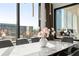 Bright dining room with marble table, seating for six, and view of city buildings at 2828 Peachtree Nw Rd # 701, Atlanta, GA 30305