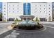 Elegant building entrance with a circular driveway and a beautiful fountain, creating a grand arrival experience at 2828 Peachtree Nw Rd # 701, Atlanta, GA 30305