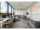Modern living room with large windows, gray sofa, and a work area at 2828 Peachtree Nw Rd # 701, Atlanta, GA 30305