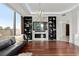 Open living room featuring hardwood floors, modern fireplace, and floor to ceiling windows at 2828 Peachtree Nw Rd # 701, Atlanta, GA 30305