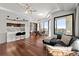Open-concept living room with hardwood floors, modern lighting, and expansive windows at 2828 Peachtree Nw Rd # 701, Atlanta, GA 30305