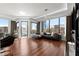Bright living room boasts hardwood floors, floor to ceiling windows, and comfortable contemporary furnishings at 2828 Peachtree Nw Rd # 701, Atlanta, GA 30305