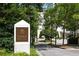 Entrance featuring a stately sign amidst lush landscaping, leading to a grand residence at 2828 Peachtree Nw Rd # 701, Atlanta, GA 30305