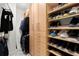 Spacious walk-in closet with custom shelving, cabinets, and ample storage space for clothes and shoes at 2828 Peachtree Nw Rd # 701, Atlanta, GA 30305