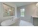 Bathroom featuring a soaking tub beneath a window, and a glass shower at 31 Homesite Cooper E Cv, Fayetteville, GA 30214