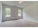 A bedroom with carpeted floors and two windows providing ample natural light at 31 Homesite Cooper E Cv, Fayetteville, GA 30214