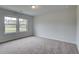 A bedroom with carpeted floors and two windows providing ample natural light at 31 Homesite Cooper E Cv, Fayetteville, GA 30214