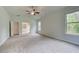 Bright bedroom featuring neutral carpet, with a view to an adjoining bathroom with a soaking tub at 31 Homesite Cooper E Cv, Fayetteville, GA 30214