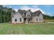 Beautiful two-story home with a landscaped front yard, showcasing architectural details and curb appeal at 31 Homesite Cooper E Cv, Fayetteville, GA 30214