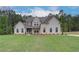 Charming two-story home featuring a mix of brick and siding, complemented by a well-maintained lawn at 31 Homesite Cooper E Cv, Fayetteville, GA 30214