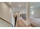Upstairs hallway with carpet flooring and decorative wrought iron handrail at 31 Homesite Cooper E Cv, Fayetteville, GA 30214