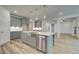 Open-concept kitchen featuring stainless appliances, a farmhouse sink, and modern gray cabinets at 31 Homesite Cooper E Cv, Fayetteville, GA 30214
