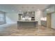 Kitchen with a large island and pendant lighting, flowing to the living area at 31 Homesite Cooper E Cv, Fayetteville, GA 30214