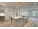 Kitchen island featuring stainless steel appliances, farmhouse sink, and shaker cabinets at 31 Homesite Cooper E Cv, Fayetteville, GA 30214