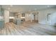 Open-concept kitchen with stainless steel appliances, gray cabinets, farmhouse sink, and hardwood style floors at 31 Homesite Cooper E Cv, Fayetteville, GA 30214